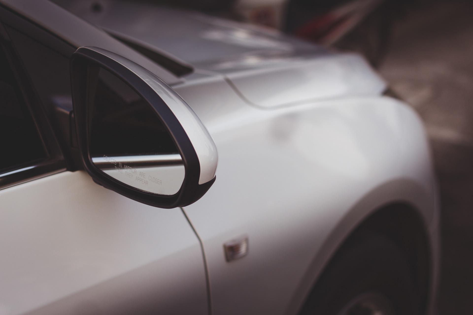 A rearview mirror of a silver car