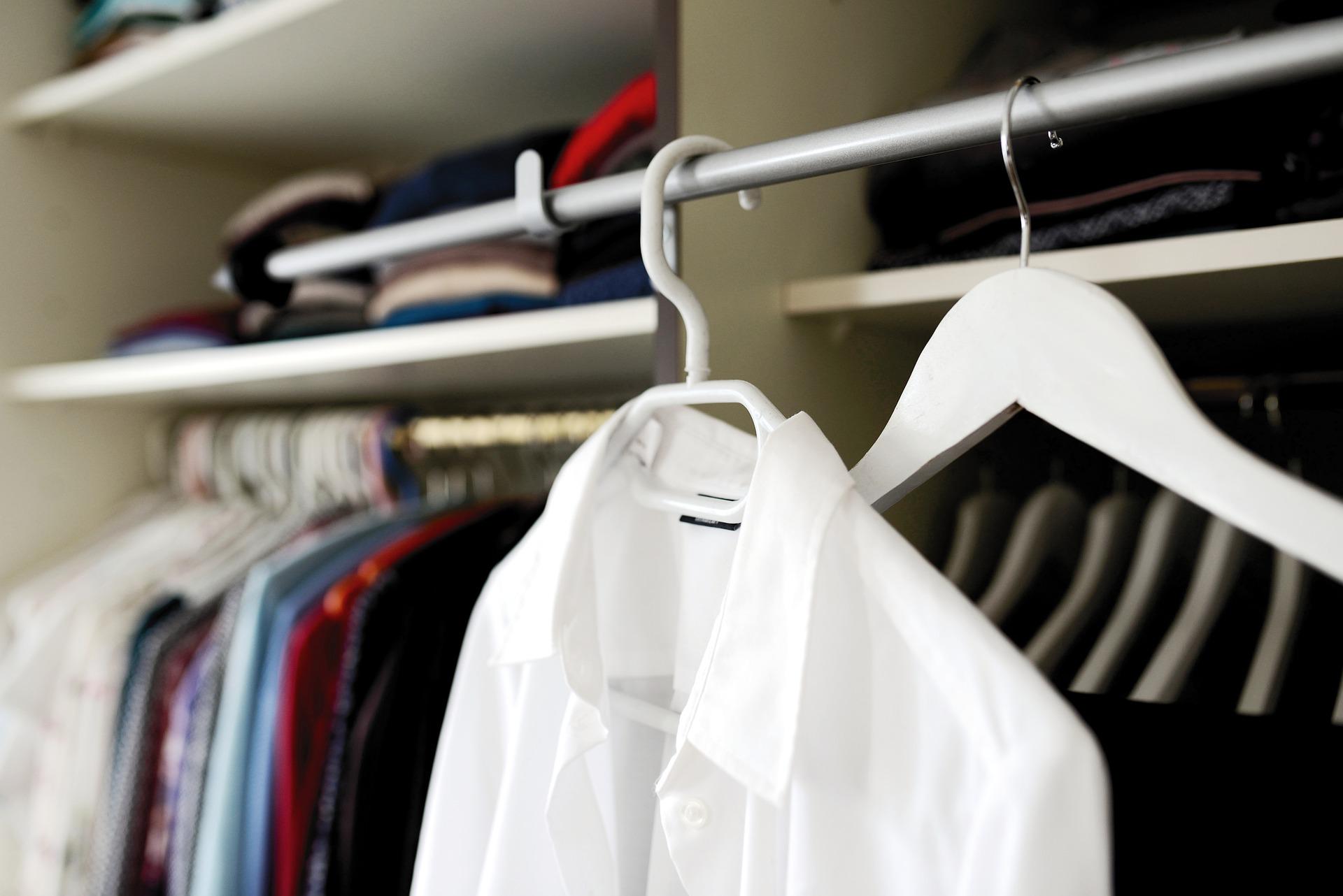 A white shirt and hanger on a clothes rack